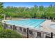 Community pool with lounge chairs and umbrellas, surrounded by lush greenery at 6250 Vista Crossing Way, Cumming, GA 30028