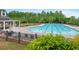Community pool with sunshades and lounge chairs, surrounded by lush greenery at 6250 Vista Crossing Way, Cumming, GA 30028