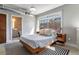 A cozy bedroom featuring contemporary furniture, a striped rug, and an en-suite bathroom at 791 Wylie Se St # 912, Atlanta, GA 30316