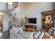 Bright living room with spiral staircase, comfortable seating, modern furnishings, and an entertainment center at 791 Wylie Se St # 912, Atlanta, GA 30316