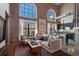 Bright living room features exposed brick, soaring ceilings, large windows, and modern decor with connecting kitchen at 791 Wylie Se St # 912, Atlanta, GA 30316