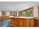 Basement bar area with wood paneling, serving counter and cabinetry at 1498 Camp Point Ne Ct, Roswell, GA 30075