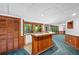 Finished basement featuring a wet bar with wood paneling and a view of the property at 1498 Camp Point Ne Ct, Roswell, GA 30075