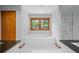 Bathroom showcases a luxurious tub and a glass-enclosed shower at 1498 Camp Point Ne Ct, Roswell, GA 30075