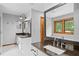 Modern bathroom with dual sinks, dark countertop, and a soaking tub at 1498 Camp Point Ne Ct, Roswell, GA 30075
