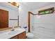 Well-lit bathroom featuring a single sink, toilet, bathtub and shower at 1498 Camp Point Ne Ct, Roswell, GA 30075