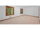Spacious bedroom with carpeted floor, two windows and wood trim at 1498 Camp Point Ne Ct, Roswell, GA 30075