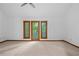 Bedroom with a door to the outside and three windows overlooking a lush backyard at 1498 Camp Point Ne Ct, Roswell, GA 30075