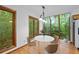 Sun-drenched breakfast nook with wood floors and lush backyard views at 1498 Camp Point Ne Ct, Roswell, GA 30075
