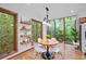 Charming breakfast nook with a round table, bright natural light, hardwood floors, and built-in shelving at 1498 Camp Point Ne Ct, Roswell, GA 30075