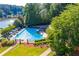 Aerial view of a community pool with lounge chairs surrounded by greenery, offering a relaxing recreational space at 1498 Camp Point Ne Ct, Roswell, GA 30075
