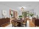 Bright dining room featuring a wood table with seating for six, hardwood floors, and a large window with a view at 1498 Camp Point Ne Ct, Roswell, GA 30075