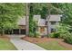 Charming exterior featuring stone accents, neutral siding, well-maintained landscaping, and an attached two-car garage at 1498 Camp Point Ne Ct, Roswell, GA 30075