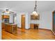 Open kitchen with island cooktop, hardwood floors, and ample cabinet space at 1498 Camp Point Ne Ct, Roswell, GA 30075