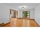 Bright living room features hardwood floors, a large window with views of lush greenery, and an inviting atmosphere at 1498 Camp Point Ne Ct, Roswell, GA 30075