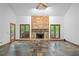 Spacious living room with stone fireplace, floor-to-ceiling windows and wood trim at 1498 Camp Point Ne Ct, Roswell, GA 30075