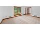 Inviting living room with plush carpeting, natural light from large window, and wood trim at 1498 Camp Point Ne Ct, Roswell, GA 30075