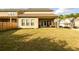 A sunny backyard with a lawn, patio, and view of neighboring homes at 2080 Abbey Rd, Roswell, GA 30076