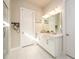 Well-lit bathroom with dual vanity, bright white cabinets, and framed mirrors at 2080 Abbey Rd, Roswell, GA 30076