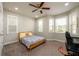 Bedroom with three large windows, neutral walls, carpeted floors, and a ceiling fan at 2080 Abbey Rd, Roswell, GA 30076