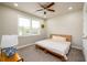 Bedroom with a ceiling fan, bright window, and a cozy bed with a neutral color palette at 2080 Abbey Rd, Roswell, GA 30076
