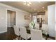 Elegant dining room with a glass table, seating for six, and modern pendant lighting at 2080 Abbey Rd, Roswell, GA 30076