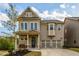 Charming two-story home features a manicured lawn and a welcoming covered front porch at 2080 Abbey Rd, Roswell, GA 30076