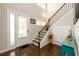 Bright foyer features hardwood floors, a staircase with wood railing, and ample natural light at 2080 Abbey Rd, Roswell, GA 30076