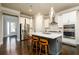 Stylish kitchen featuring a central island with seating, stainless steel appliances, and modern pendant lights at 2080 Abbey Rd, Roswell, GA 30076