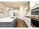 Well-equipped kitchen with white cabinets, stainless steel appliances, and a large central island at 2080 Abbey Rd, Roswell, GA 30076