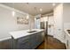 Bright kitchen featuring a center island with bar seating, modern stainless steel appliances, and stylish lighting at 2080 Abbey Rd, Roswell, GA 30076