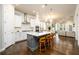 A kitchen featuring a large island with barstool seating, white cabinets, and stainless steel appliances at 2080 Abbey Rd, Roswell, GA 30076