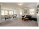 Well-lit living space with plenty of room, lots of windows, and a shiplap accent wall at 2080 Abbey Rd, Roswell, GA 30076