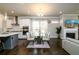 Open-concept living space featuring a dining area, modern kitchen, and comfortable seating at 2080 Abbey Rd, Roswell, GA 30076