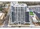 Stunning full building aerial view of a modern high-rise apartment complex with luxurious amenities like a tennis court at 2425 Peachtree Rd # 508, Atlanta, GA 30305