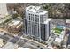 Sweeping aerial view showcases this upscale high-rise apartment building with a rooftop tennis court and nearby parking at 2425 Peachtree Rd # 508, Atlanta, GA 30305