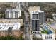 Stunning aerial view showcasing a modern high-rise with a rooftop pool, tennis court, and lush landscaping in an urban area at 2425 Peachtree Rd # 508, Atlanta, GA 30305