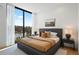 Bright bedroom features a large window overlooking the pool and seating area at 2425 Peachtree Rd # 508, Atlanta, GA 30305