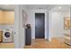 Hallway with modern front door, statement art, access to laundry room and view to the living room at 2425 Peachtree Rd # 508, Atlanta, GA 30305
