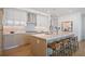 Modern kitchen with white cabinets, stainless steel appliances, and a spacious island with seating at 2425 Peachtree Rd # 508, Atlanta, GA 30305