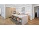 A modern kitchen with an island, stainless steel appliances, and sleek white and wood cabinets at 2425 Peachtree Rd # 508, Atlanta, GA 30305