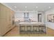 Well-lit, modern kitchen with a large island, stainless steel appliances, and wooden floors at 2425 Peachtree Rd # 508, Atlanta, GA 30305