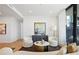 Spacious living room with stylish furniture, hardwood floors, and access to the balcony at 2425 Peachtree Rd # 508, Atlanta, GA 30305