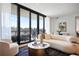 Bright living room featuring modern furniture, floor-to-ceiling windows, and a sophisticated decor at 2425 Peachtree Rd # 508, Atlanta, GA 30305