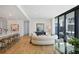 Open living area with kitchen, hardwood floors and modern furniture and access to outdoor patio at 2425 Peachtree Rd # 508, Atlanta, GA 30305