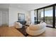 Cozy living room with hardwood floors, a comfortable couch, and access to the balcony at 2425 Peachtree Rd # 508, Atlanta, GA 30305