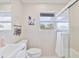 Bright bathroom featuring tiled walls, a modern sink and toilet, and a glass-enclosed shower for a clean, sleek design at 4060 Haverhill Ne Dr # F, Atlanta, GA 30342