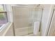 Elegant bathroom features a glass-enclosed tub-shower combo with tiled walls and modern hardware and bright lighting at 4060 Haverhill Ne Dr # F, Atlanta, GA 30342