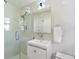 Modern bathroom featuring glass shower doors, sleek white vanity, and contemporary fixtures at 4060 Haverhill Ne Dr # F, Atlanta, GA 30342