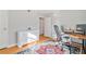 Bright bedroom showcasing hardwood floors, a decorative rug, and a stylish desk area at 4060 Haverhill Ne Dr # F, Atlanta, GA 30342